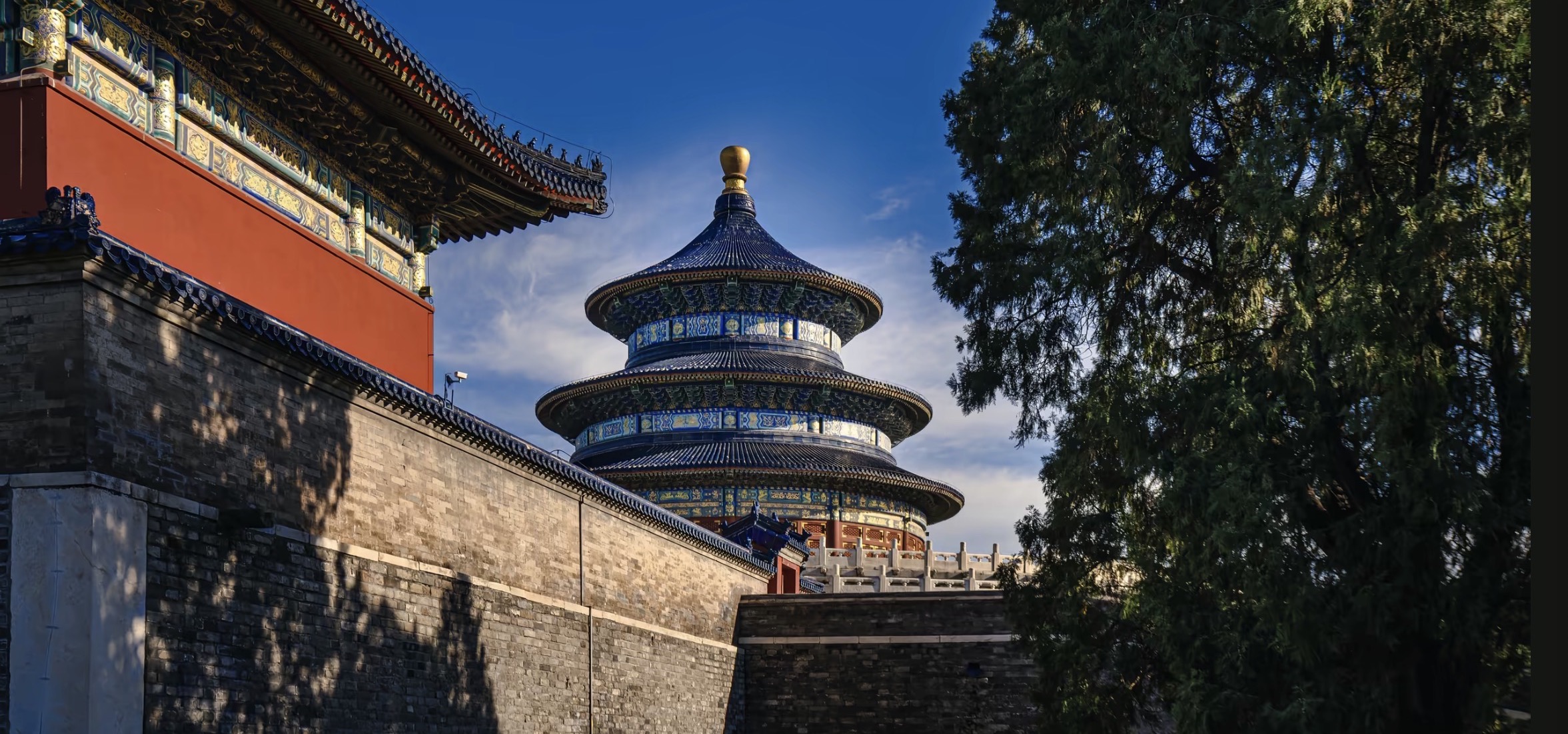 Temple of Heaven architecture in Beijing with blue glazed tiles and pine trees